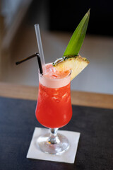 Strawberry pineapple cocktail served in a glass