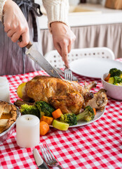 woman preparing thanksgiving dinner at home kitchen, decorating