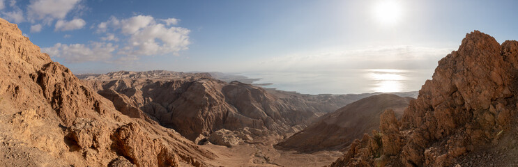 Sunrise  over the Dead Sea near mountains of stone desert near the Khatsatson stream, on the Israeli side of the Dead Sea, near Jerusalem in Israel