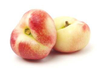 ripe flat peach on white background