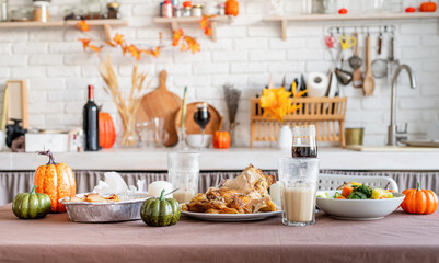 front view of thanksgiving table after feast, leftovers and dirty dishes