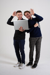 Two handsome guys. Young gay couple with laptop.	