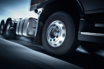 Fast Spinning Truck Wheels. Semi Truck Driving on the Road  Shipping Freight Truck. Logistics Cargo Transport Logistics.