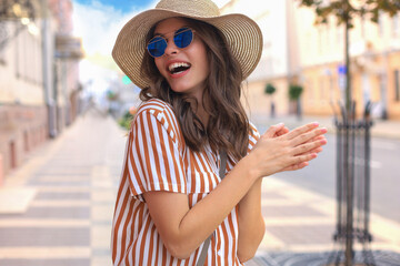 Portrait fashion woman is posing in the city, summer street fashion. Laughing and smiling portrait.