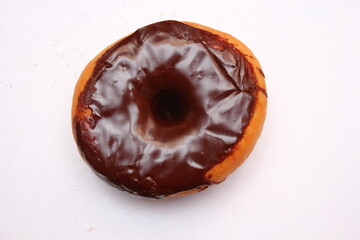 Chocolate Donuts laid on a white background