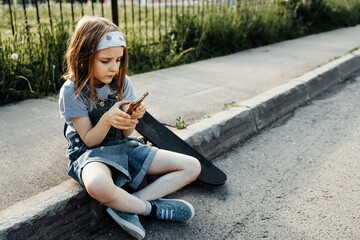 A girl learns to ride a skateboard