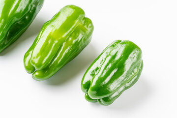 Green peppers on white background