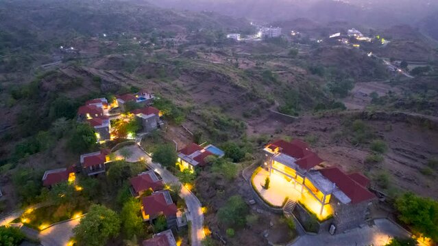 aerial drone shot showing huge resort getaway in the middle of mountains at hill station kumbalgarh, shimla, darjeeling in India. Showing the many tourist and travel places in the himalayas
