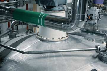 Large tank with processed aggressive liquids in workshop