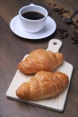 Breakfast consists of croissants, with hot black fads and fae seeds as a backdrop.