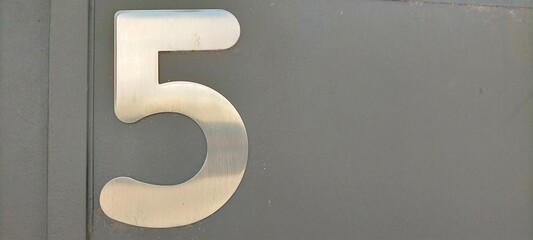 Number five,5 in shiny metal color number, on dark background