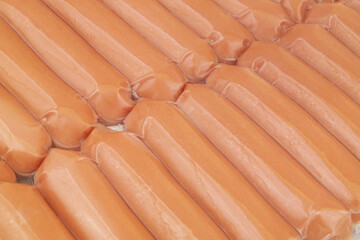 Many sausages packed in plastic as background.	