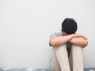 Man sadness sit bear head on the bed white background copy space