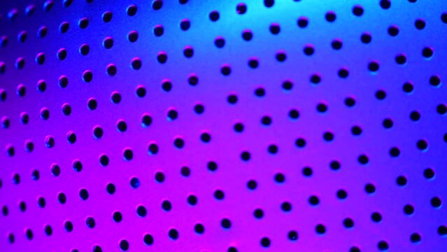 Perforated, cylinder-shaped, object rotated in the rgb led-lights