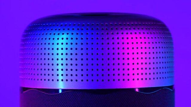 Perforated, cylinder-shaped, object rotated in the rgb led-lights
