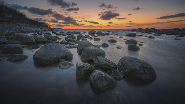 Colorful sunset on the sea rocky shore