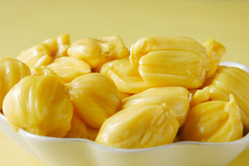 top view of slice of jackfruits in a bowl on table.