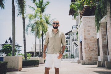 Portrait of a fashion young man posing at marina and yahts background