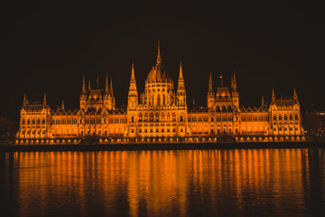 Naklejka premium Hungarian parliament building from across the Danube river at night Budapest Hungary