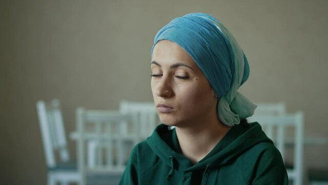 Sad woman with cancer in headscarf
