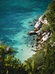 Scenic high angle view of Freedom Beach. Tropical white sand beach, rocky coastline, crystal clear turquoise sea with coral reef. Shot from John Suwan Viewpoint, Koh Tao Island, Surat Thani, Thailand.