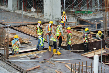 JOHOR, MALAYSIA -APRIL 30, 2016: Group of construction workers working at the construction site at...