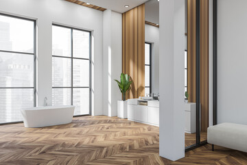 Light bathroom interior with double sink and tub near panoramic window