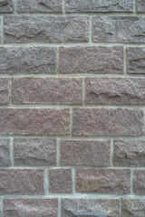 Cover page with modern granite stone wall with patterns of bricks and stones as a background, closeup, details.
