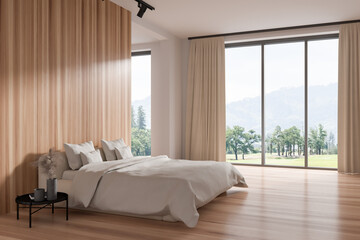 Light bedroom interior with bed and nightstand, panoramic window