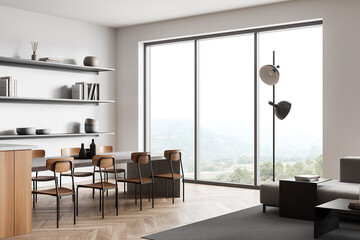 Light kitchen interior with couch and eating area, panoramic window
