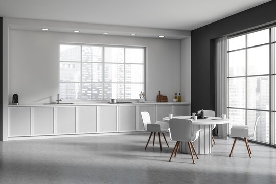Light kitchen interior with chairs and table, dining area and panoramic window
