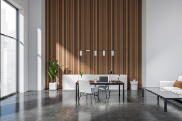 Modern office interior with seats and work desk, couch and panoramic window