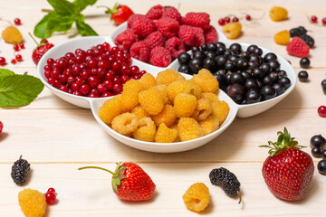 Mix of fresh berries on a rustic wooden background