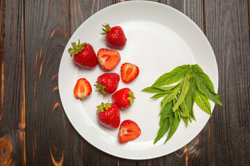 the benefits of eating fresh berries and fruits. White dish with strawberries