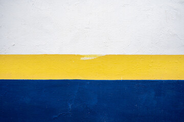 Blue, yellow and white painting on a wall, abstract painting