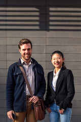 successful male and female young entrepreneurs smiling happy looking at the camera, concept of entrepreneurship and business, copy space for text