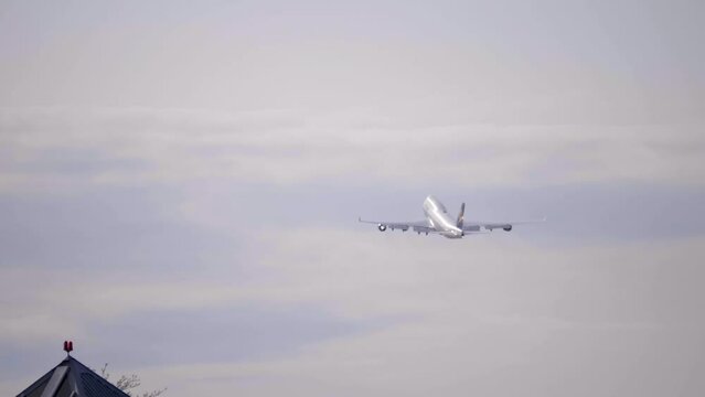 A Heavy Airliner Airplane Climbing Out After Takeoff, Sky Background.