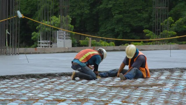 Construction workers installing a bubble deck floor.