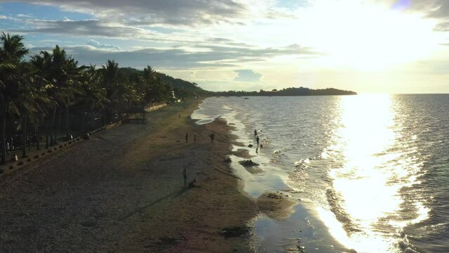 A group of family enjoying the sunset at the beach