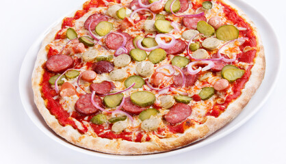 pizza with salami red onion and cornichons on white plate