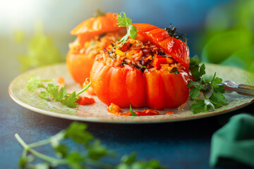 Delicious stuffed tomatoes in shape of pumpkin with rice, vegetables and meat. Concept homemade...