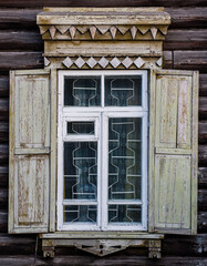 Fototapeta na wymiar A window with wooden carved sashes. Wooden architecture