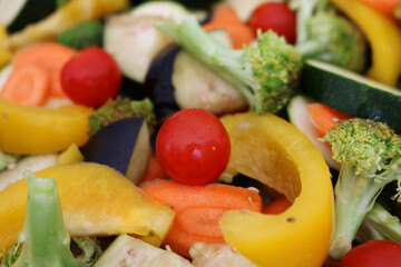 Close snapshot of various multicolored cropped vegetables. Carrot, tomatoes, zucchini, eggplant, broccoli, pepperoni