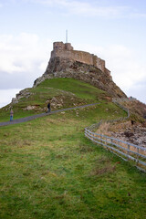 Lindisfarne England: 24th Nov 2013: Holy Island Castle view with stone wall