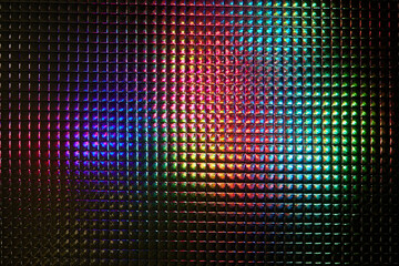 Light glares with a spectral gradient on a dark background. Multicolored abstract colorful pattern.