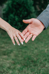 male and female hand with wedding rings