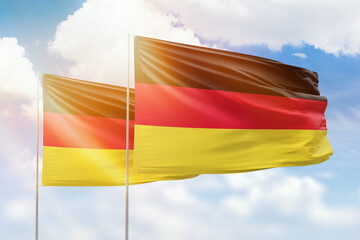 Sunny blue sky and flags of germany and germany