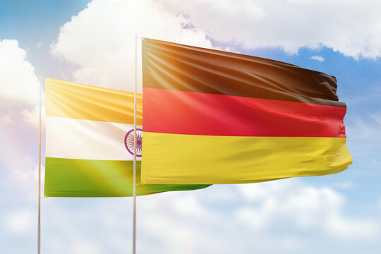 Sunny blue sky and flags of germany and india