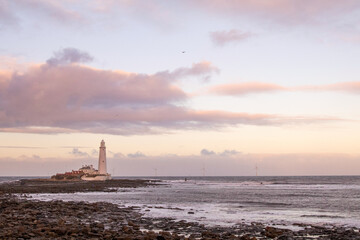Fototapeta na wymiar Whitley Bay England - .01.01.2019: Whitley Bay on a cold winter afternoon with a pink sunset