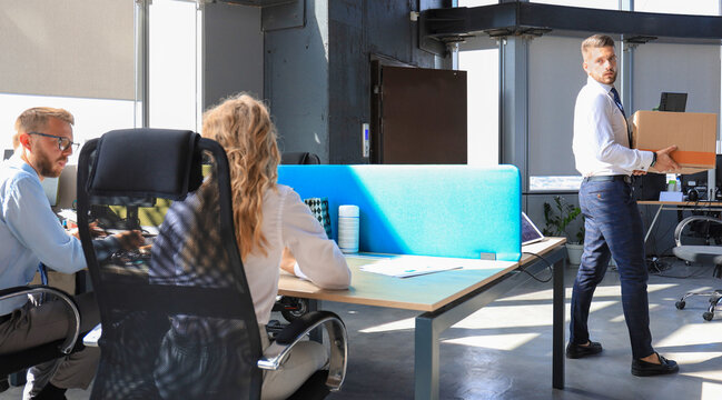 Dismissed worker going from the office with his office supplies